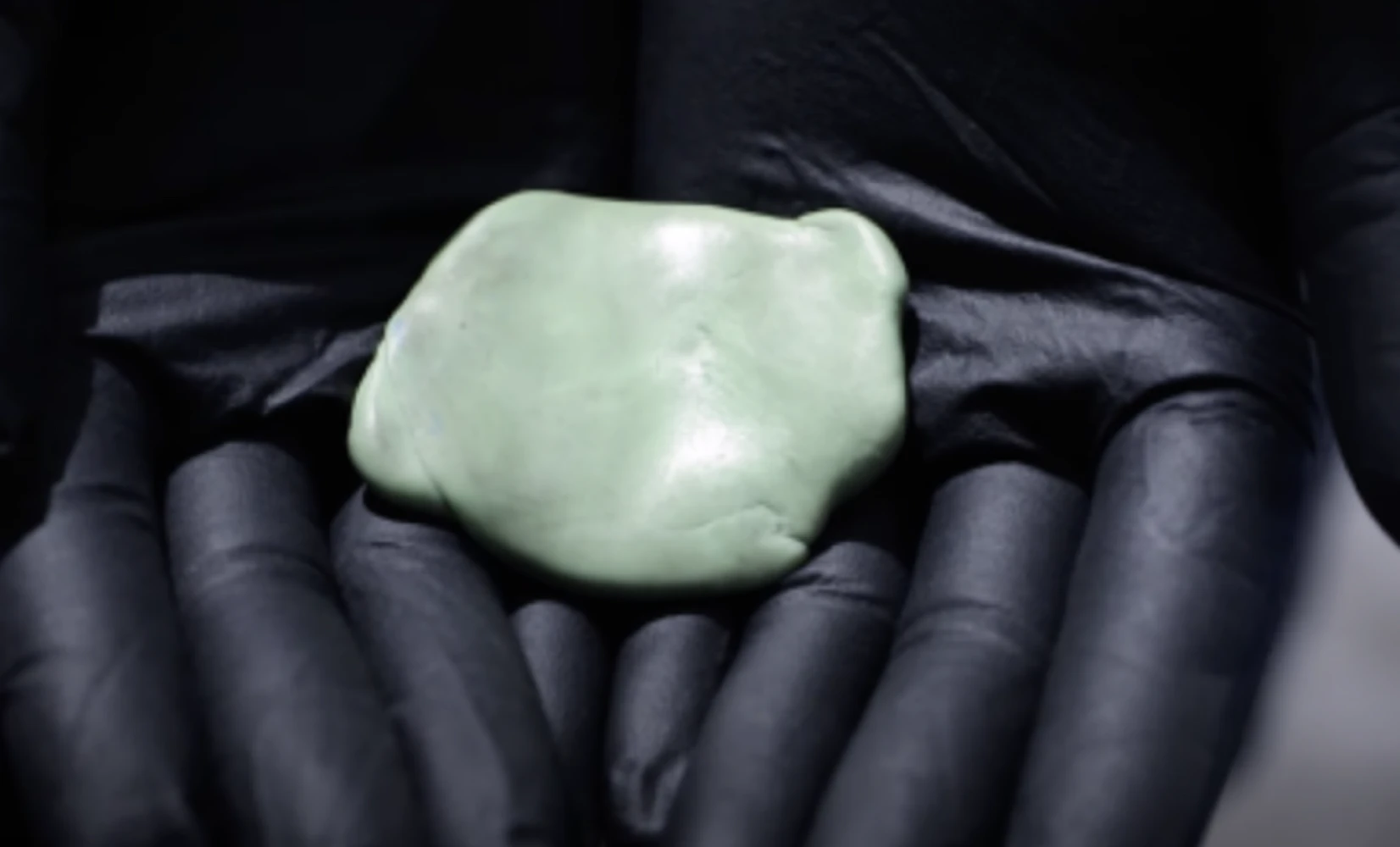 Clay bar resting in a gloved hand