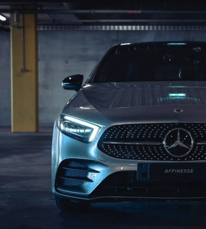 Silver Mercedes-Benz with an Affinesse number plate in a dark car park
